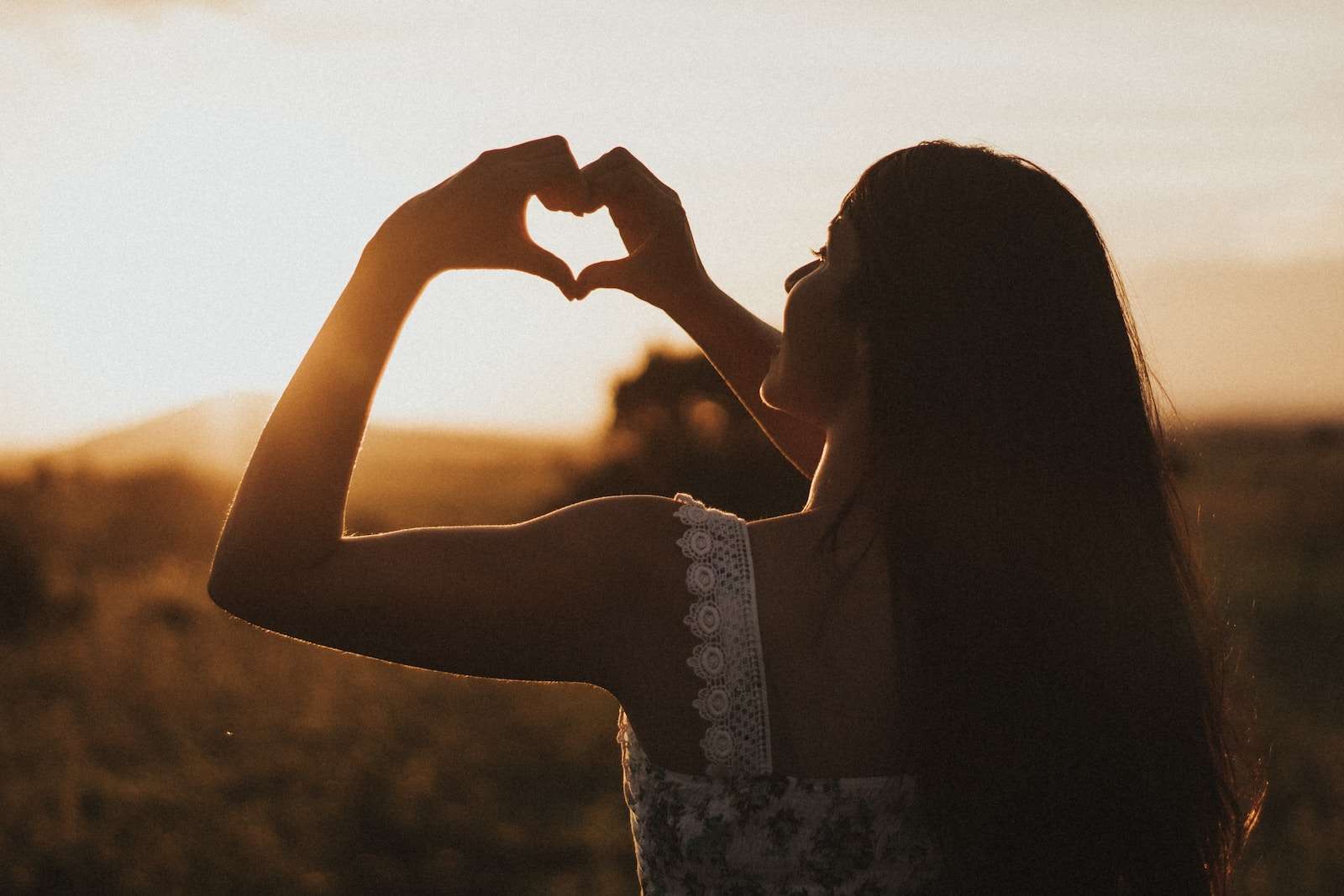 woman forming heart with her both hands