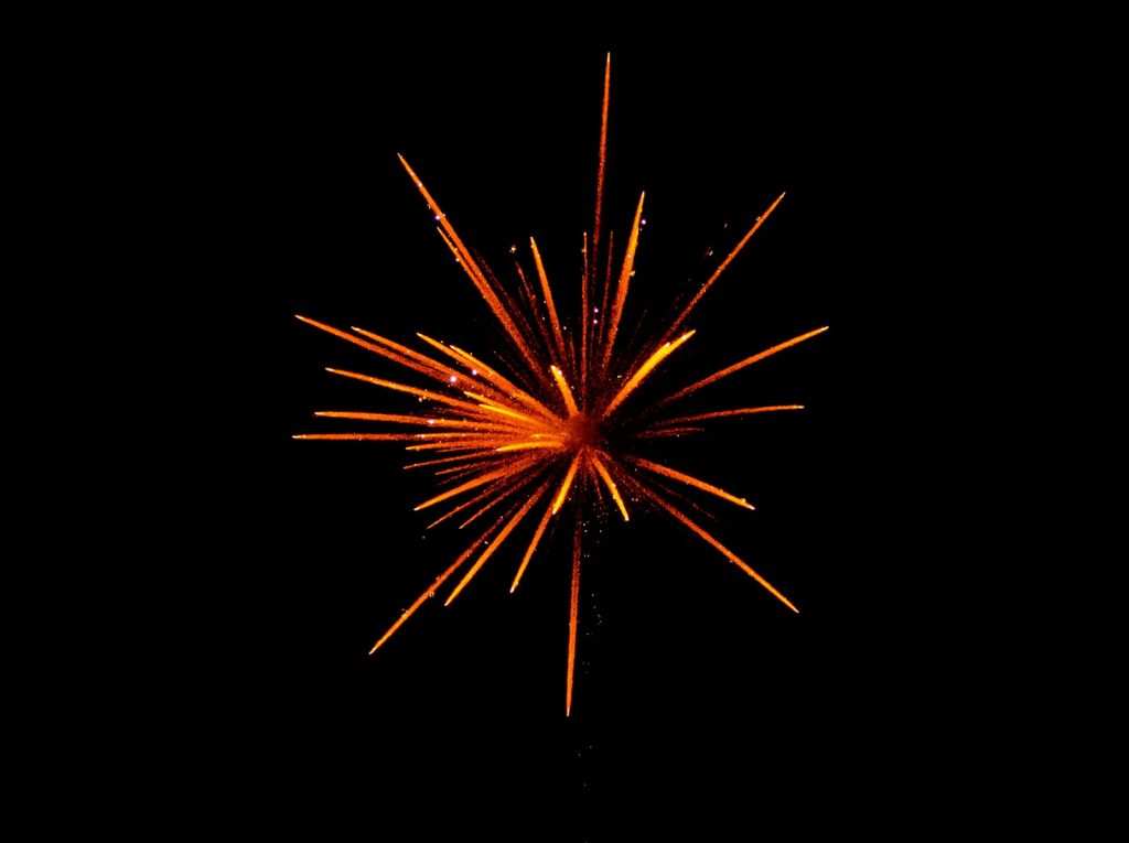 red and orange fireworks in black background